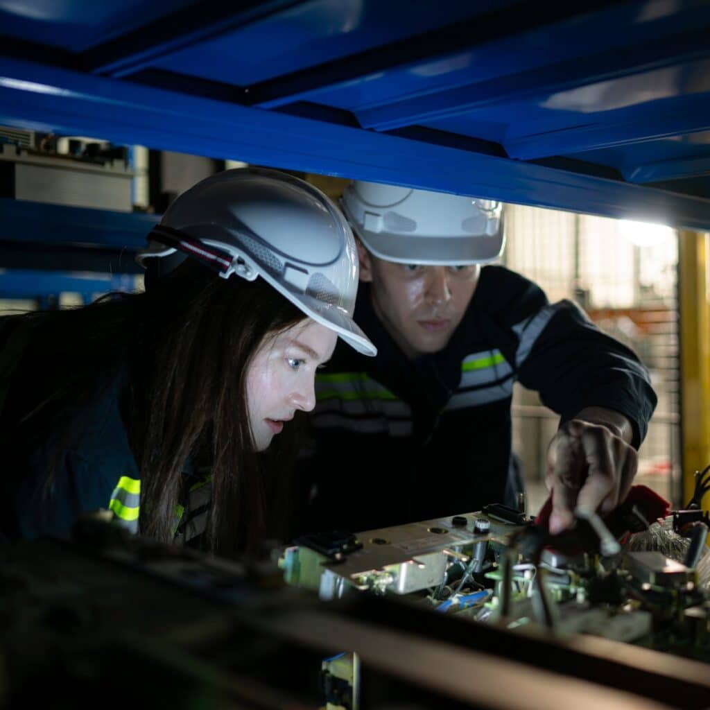 a robotics teeam working on a machine with cables